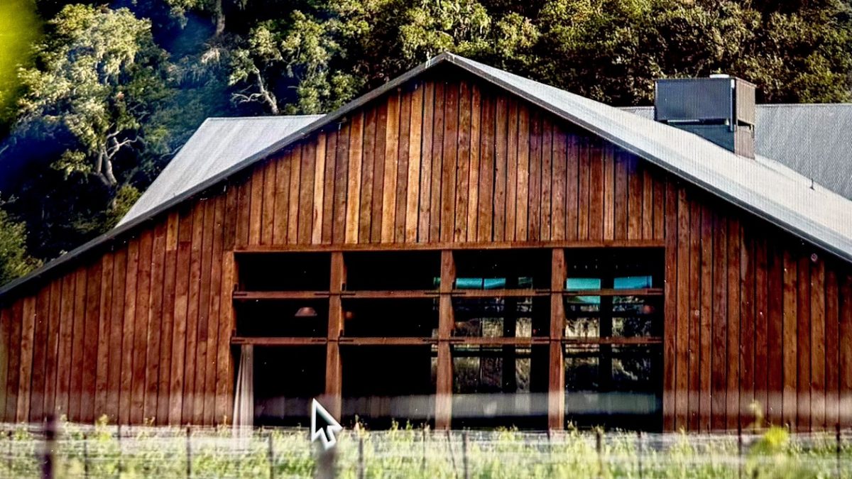 Wooden winery building at The Hilt Estate surrounded by lush greenery in Sta. Rita Hills, California.