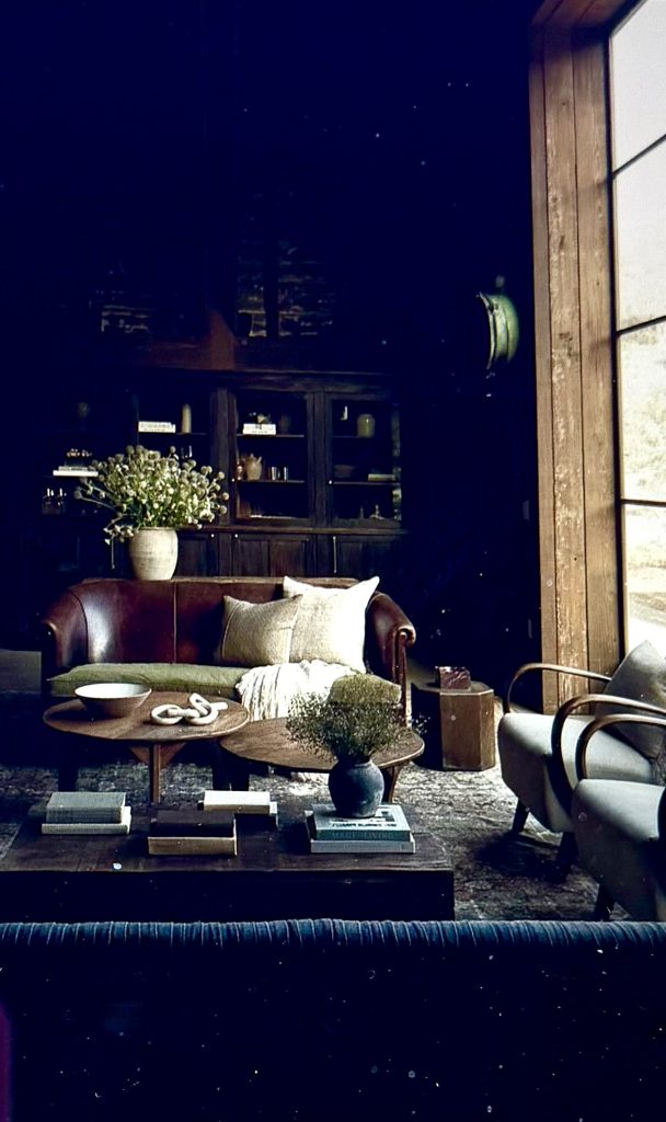 Cozy living room at The Hilt Estate featuring a leather sofa, wooden furniture, and decorative plants.