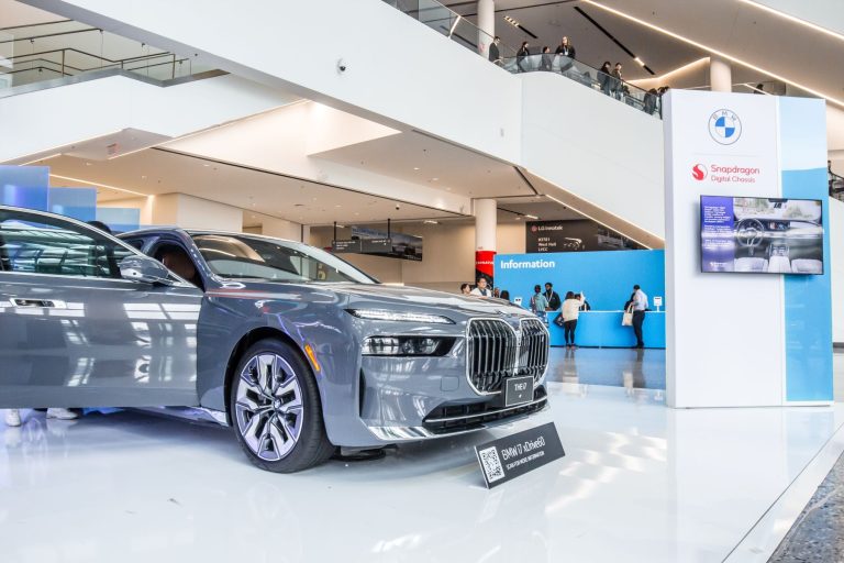 BMW luxury sedan on display at an event, showcasing futuristic design and technology for the 2026 EV lineup.