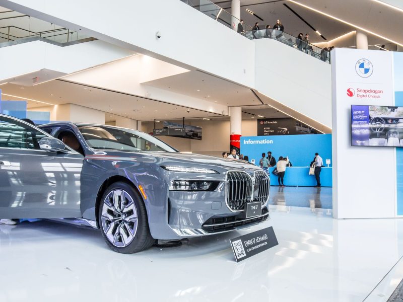 BMW luxury sedan on display at an event, showcasing futuristic design and technology for the 2026 EV lineup.