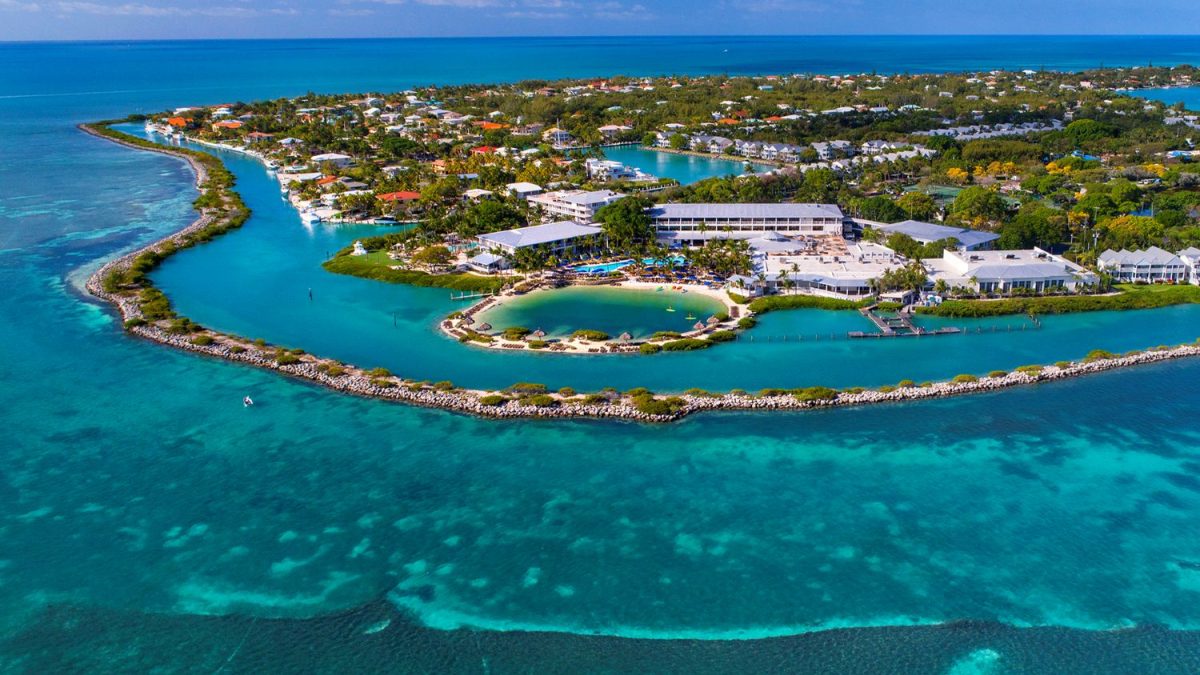 Aerial view of Hawks Cay Resort surrounded by lush greenery and clear turquoise waters in the Florida Keys.