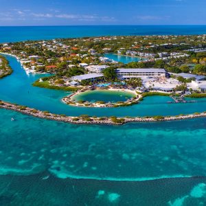 Aerial view of Hawks Cay Resort surrounded by lush greenery and clear turquoise waters in the Florida Keys.