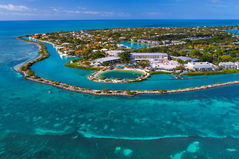 Aerial view of Hawks Cay Resort surrounded by lush greenery and clear turquoise waters in the Florida Keys.