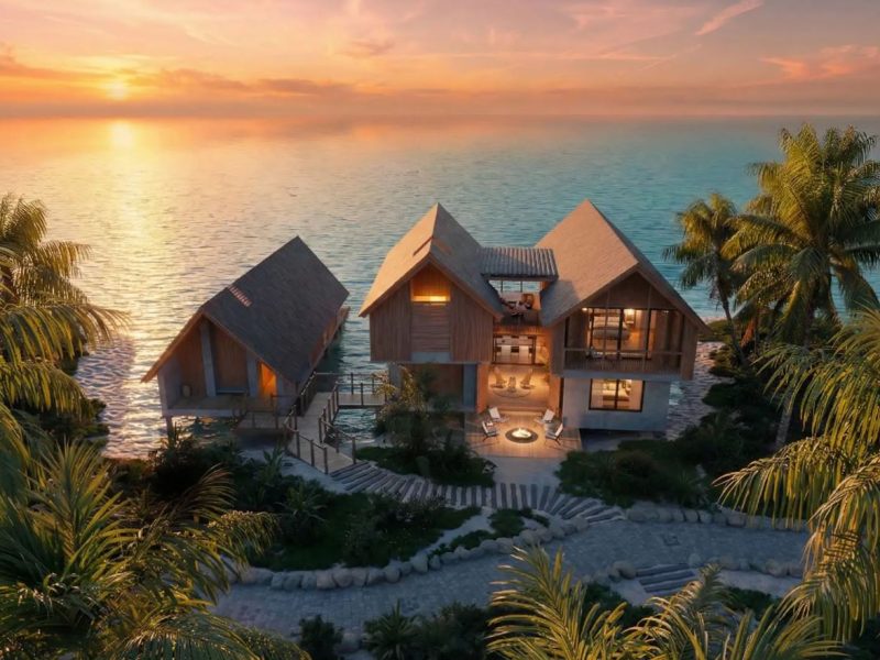 Branded residences by the ocean, featuring modern architecture and sunset views, surrounded by lush tropical landscaping.