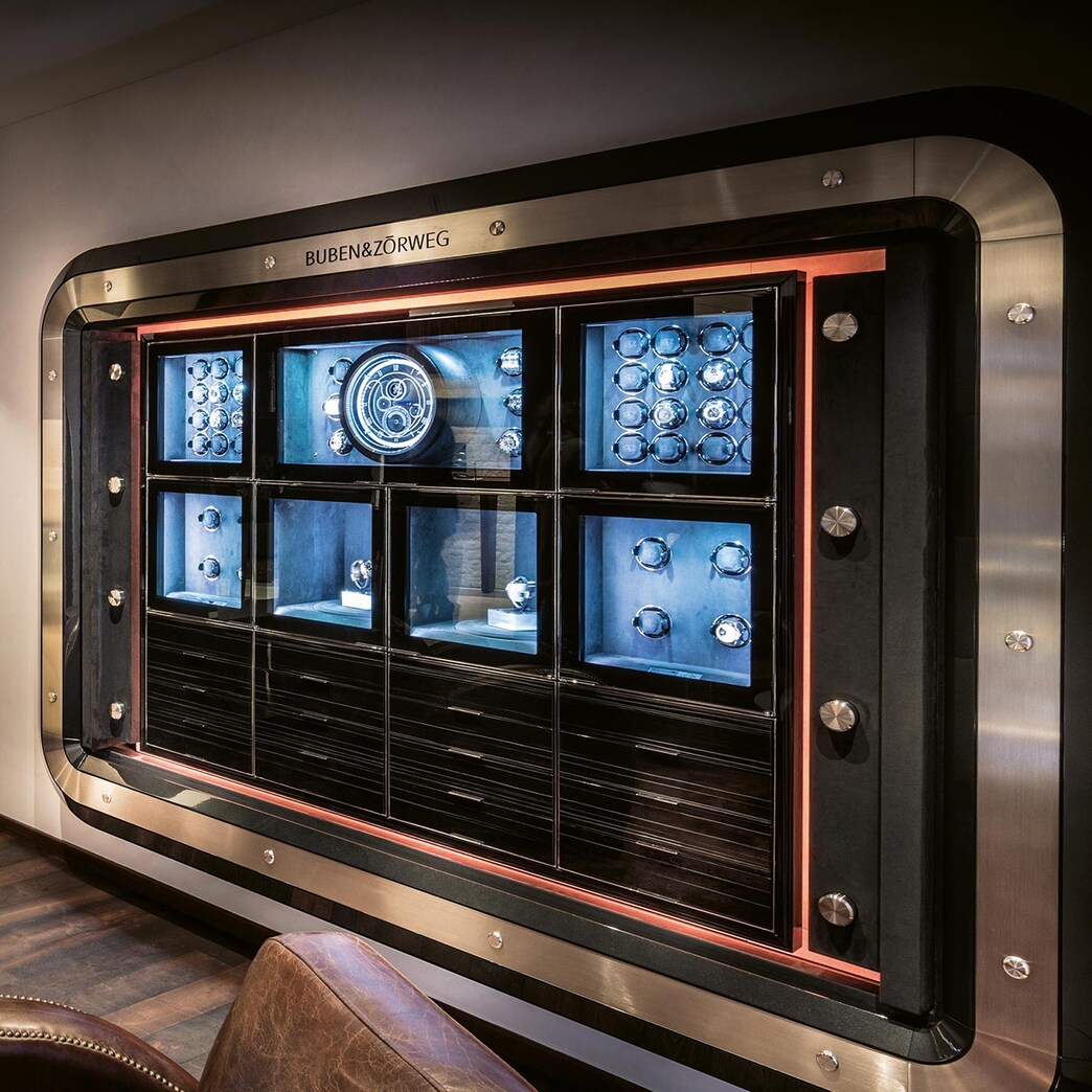 Luxury cigar lounge featuring a sleek Buben & Zörweg humidor with illuminated compartments for cigars and accessories.