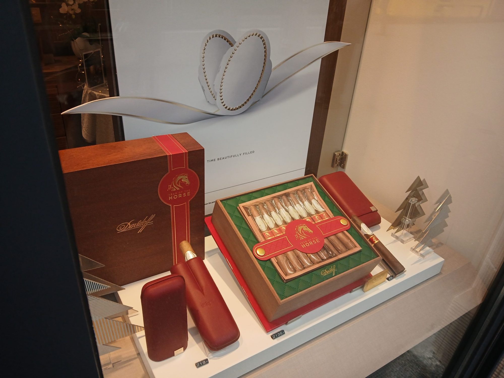 Luxury cigar lounge display featuring a selection of Davidoff cigars, accessories, and holiday-themed decor.