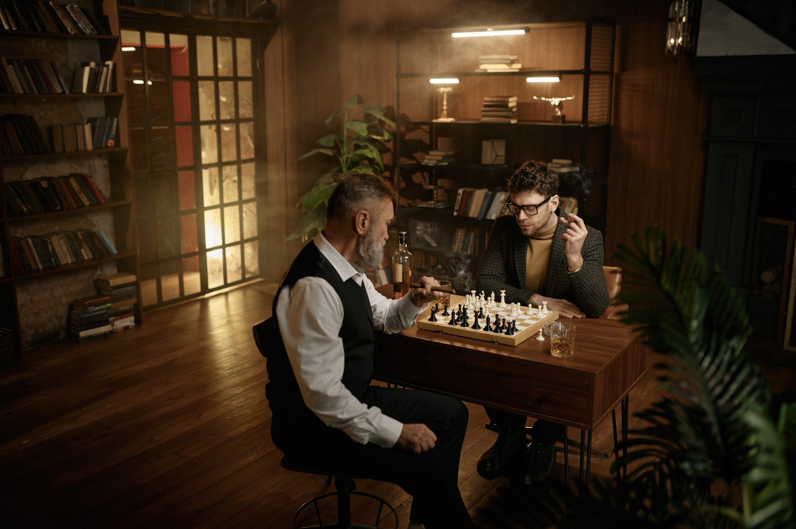 Two men play chess in a cozy lounge, surrounded by bookshelves, with a glass of whiskey and smoke in the air.
