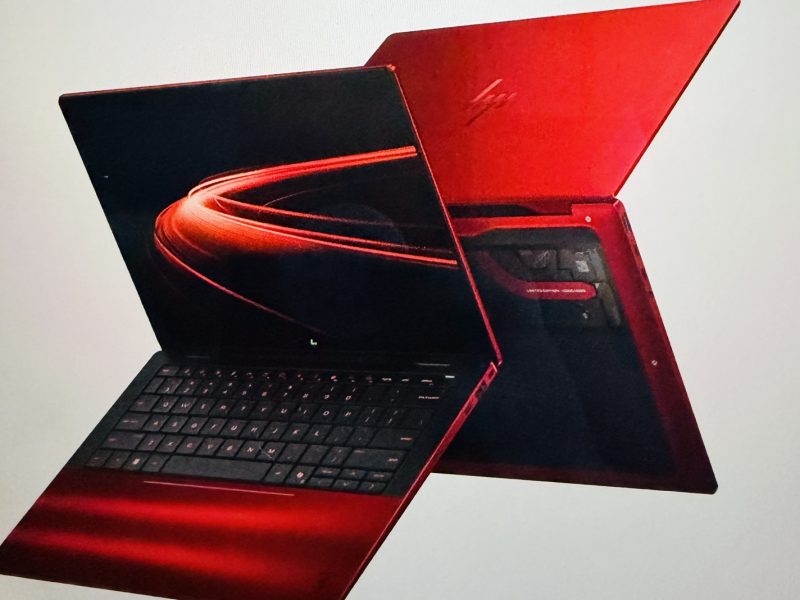 Luxury HP limited edition Scuderia Ferrari AI PC in vibrant red with an open display showing sleek design and keyboard.