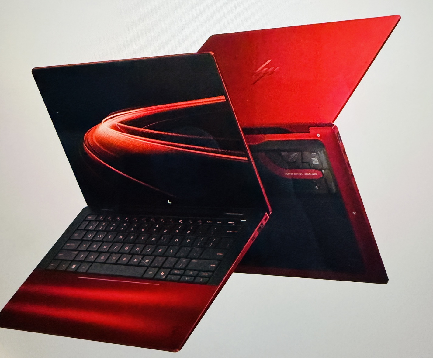 Luxury HP limited edition Scuderia Ferrari AI PC in vibrant red with an open display showing sleek design and keyboard.