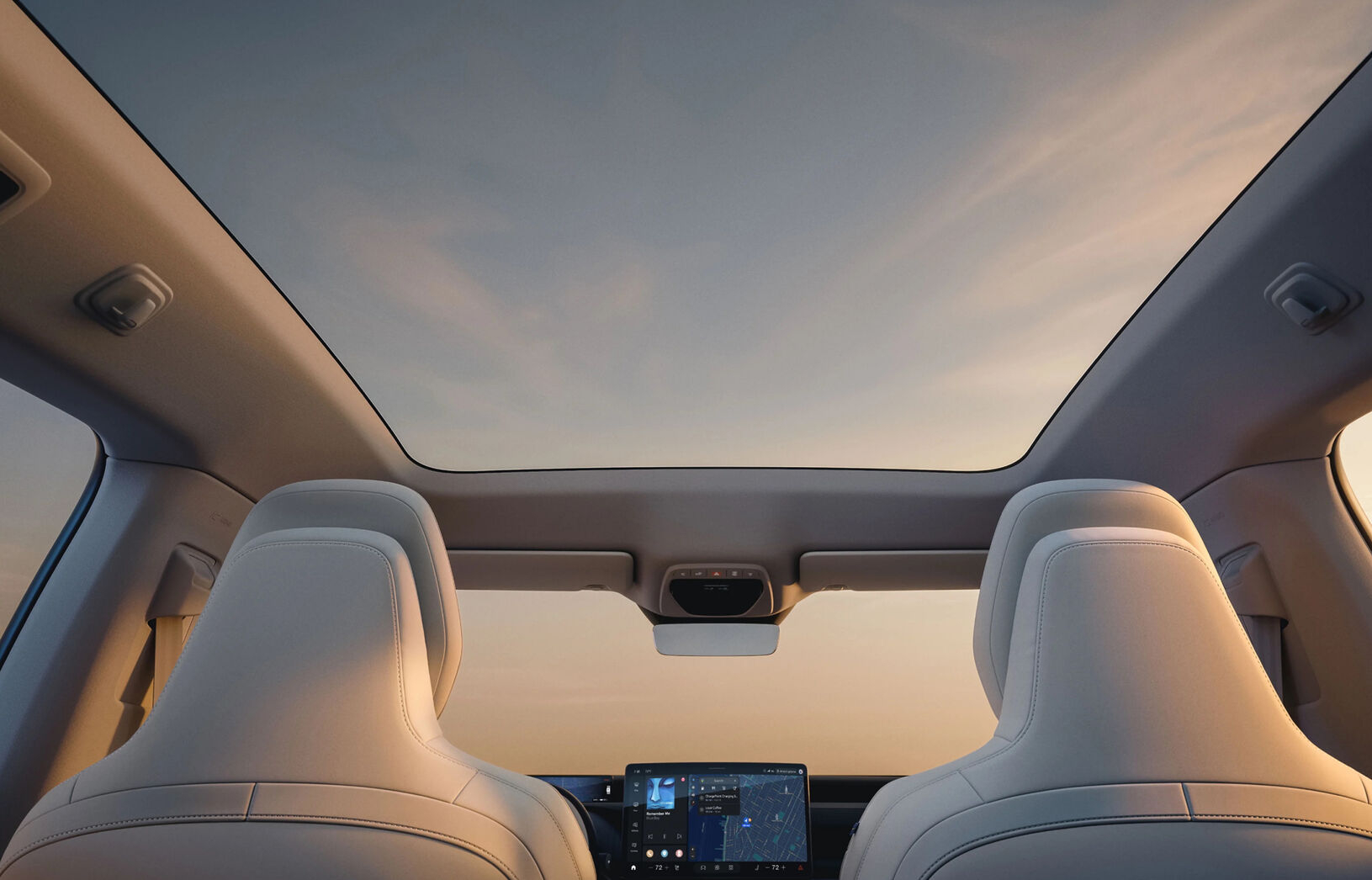 Interior view of the Volvo EX60 showcasing a panoramic moonroof and modern dashboard features.