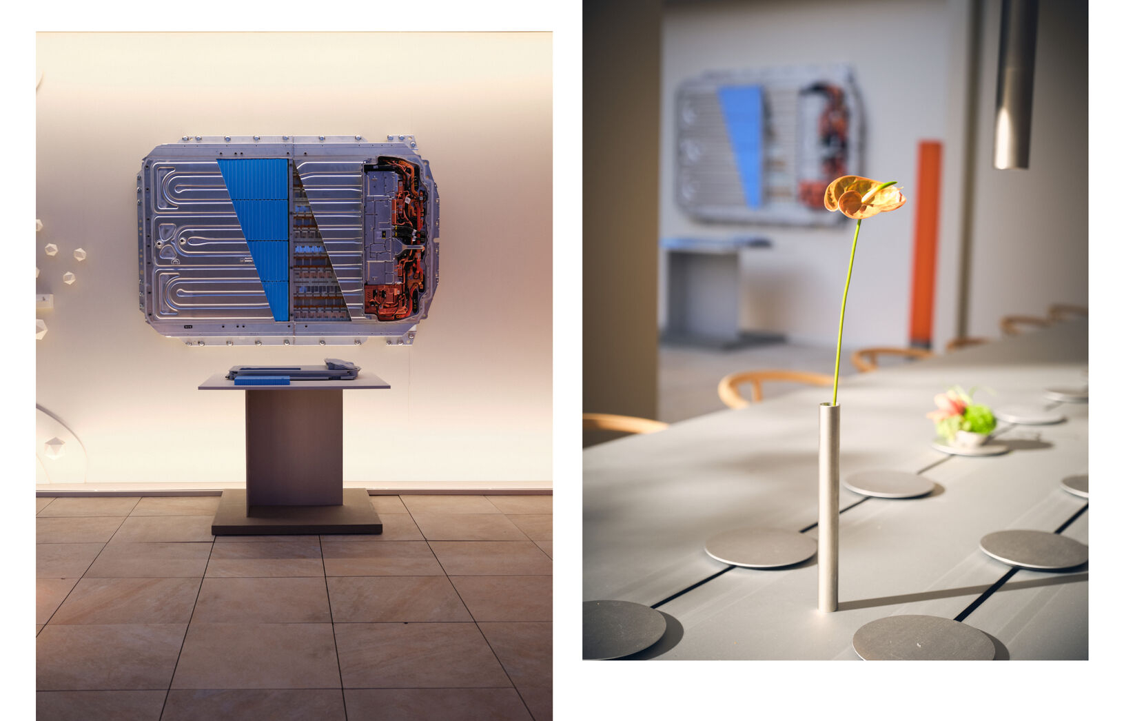 Battery pack display for Volvo EX60 showcased in an elegant event space, with a floral centerpiece on a modern table.