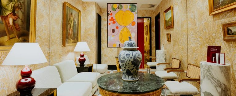 Elegant waiting area at Dr. David Jack, featuring artwork, a decorative vase, and stylish seating for clients.
