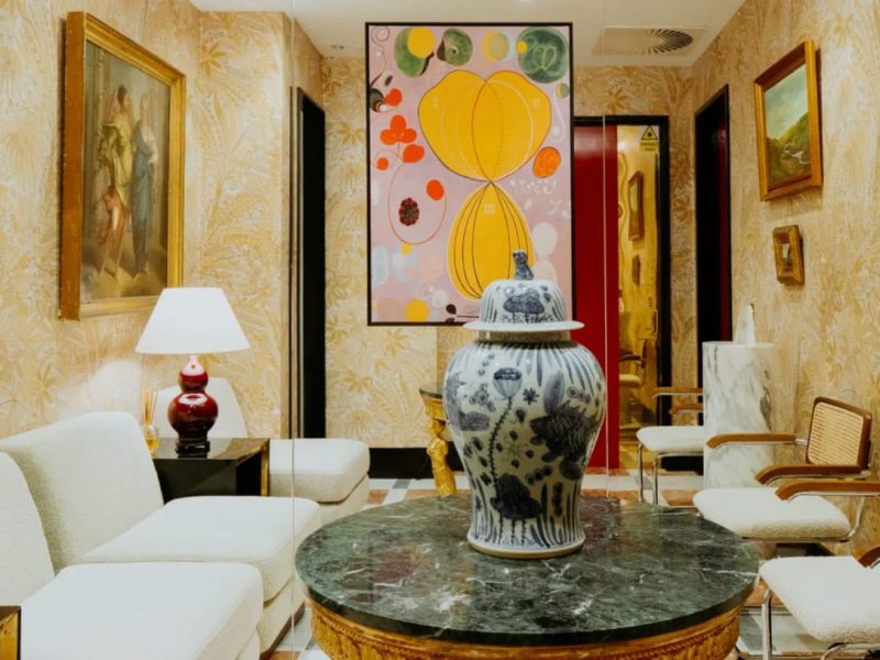 Elegant waiting area at Dr. David Jack, featuring artwork, a decorative vase, and stylish seating for clients.
