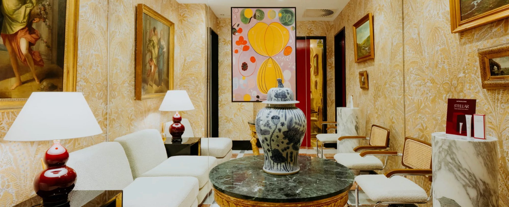 Elegant waiting area at Dr. David Jack, featuring artwork, a decorative vase, and stylish seating for clients.