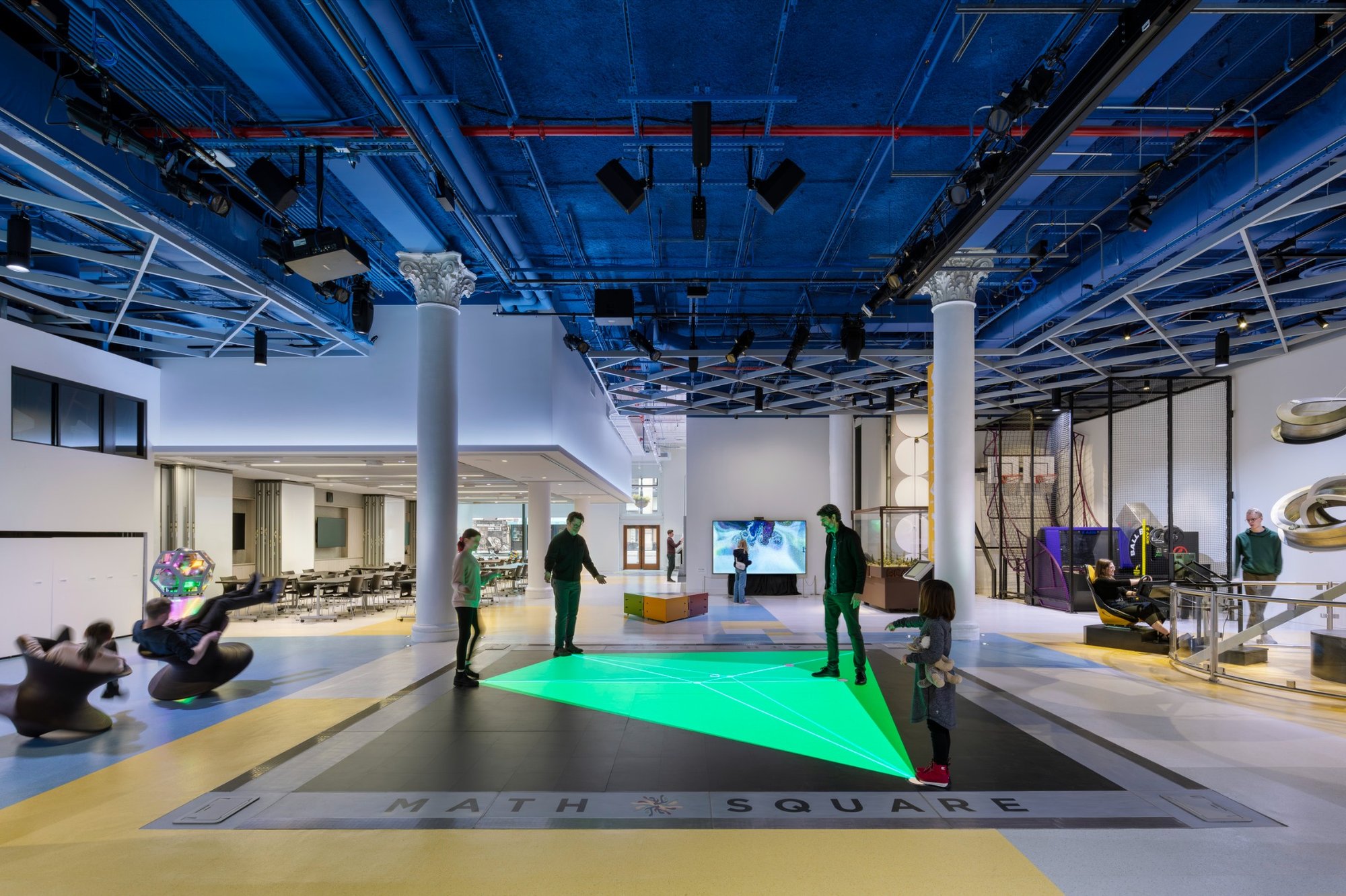 Visitors engage with interactive exhibits in the Math Square area of the National Museum of Mathematics in New York.