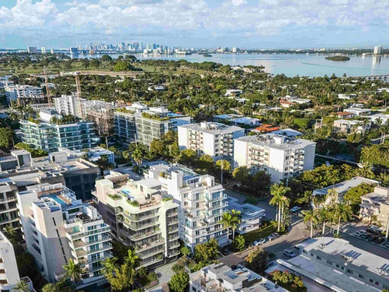 Aerial view of Bay Harbor Islands showcasing modern architecture and greenery, highlighting the new penthouse's location.