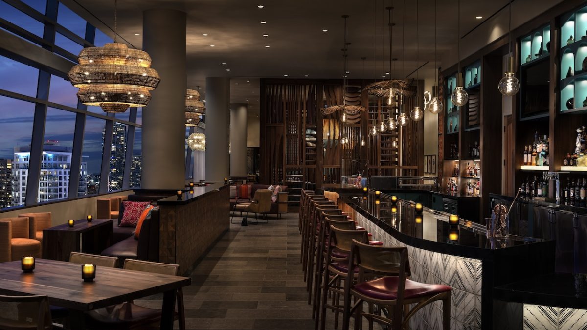 Elegant bar interior at Corteza, featuring ambient lighting, contemporary decor, and city views at The Ritz-Carlton Los Angeles.