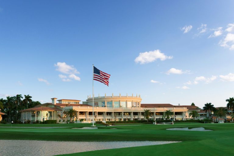 The iconic Trump Doral resort with the American flag, showcasing luxury golf course views and lush landscaping.