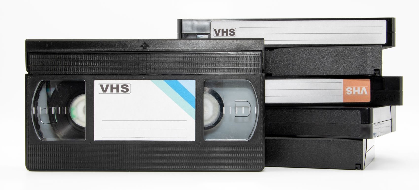 A stack of VHS tapes showcasing content preservation through digital conversion services.