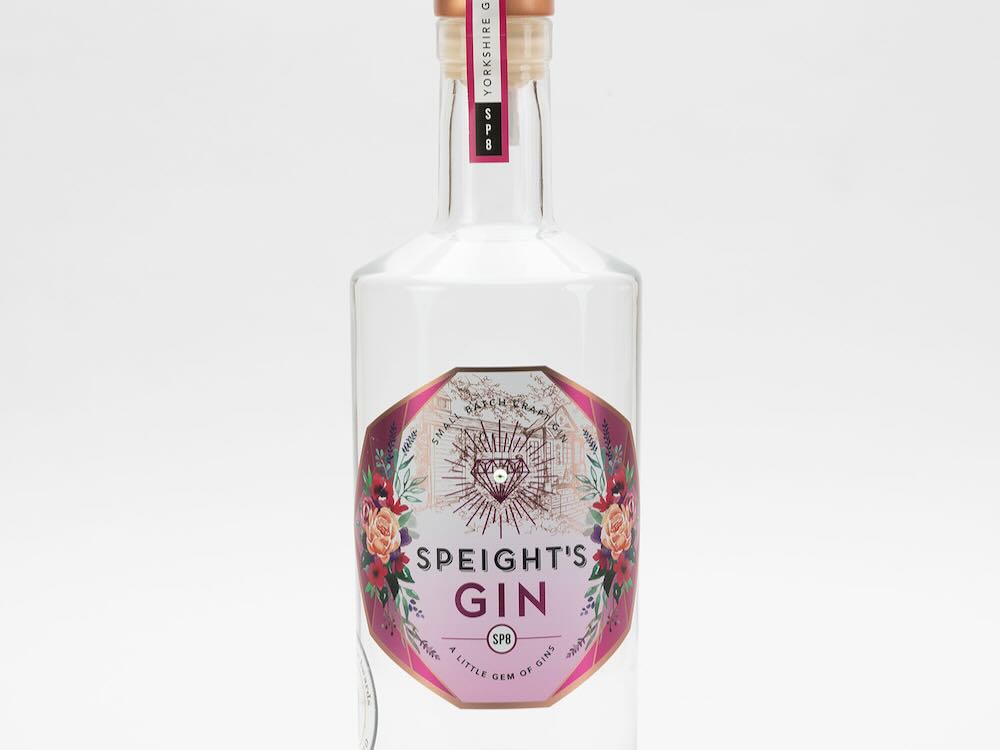 Speight's gin bottle with a floral label, celebrating World Gin Day festivities.