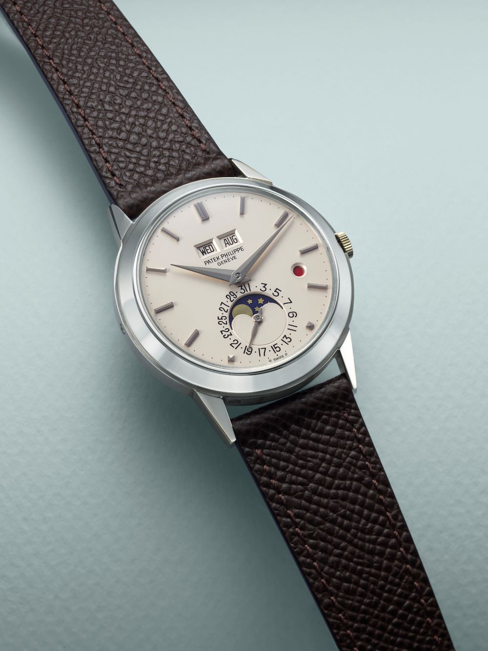 Patek Philippe Perpetual Calendar watch featuring a silver dial and brown leather strap.