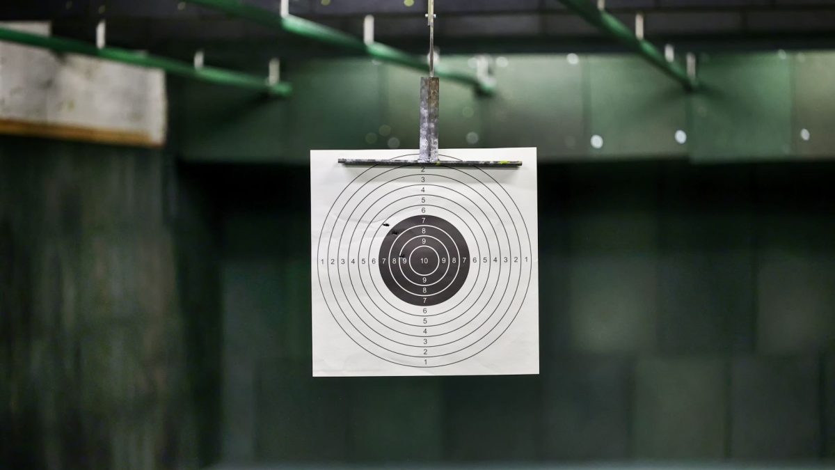 Target with concentric circles displayed in a shooting range, emphasizing accuracy for customized ammunition performance.