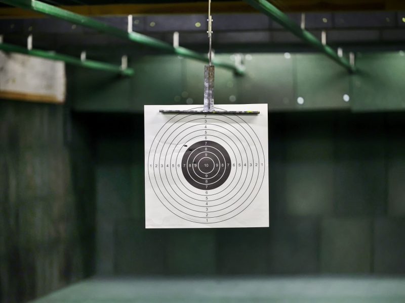 Target with concentric circles displayed in a shooting range, emphasizing accuracy for customized ammunition performance.