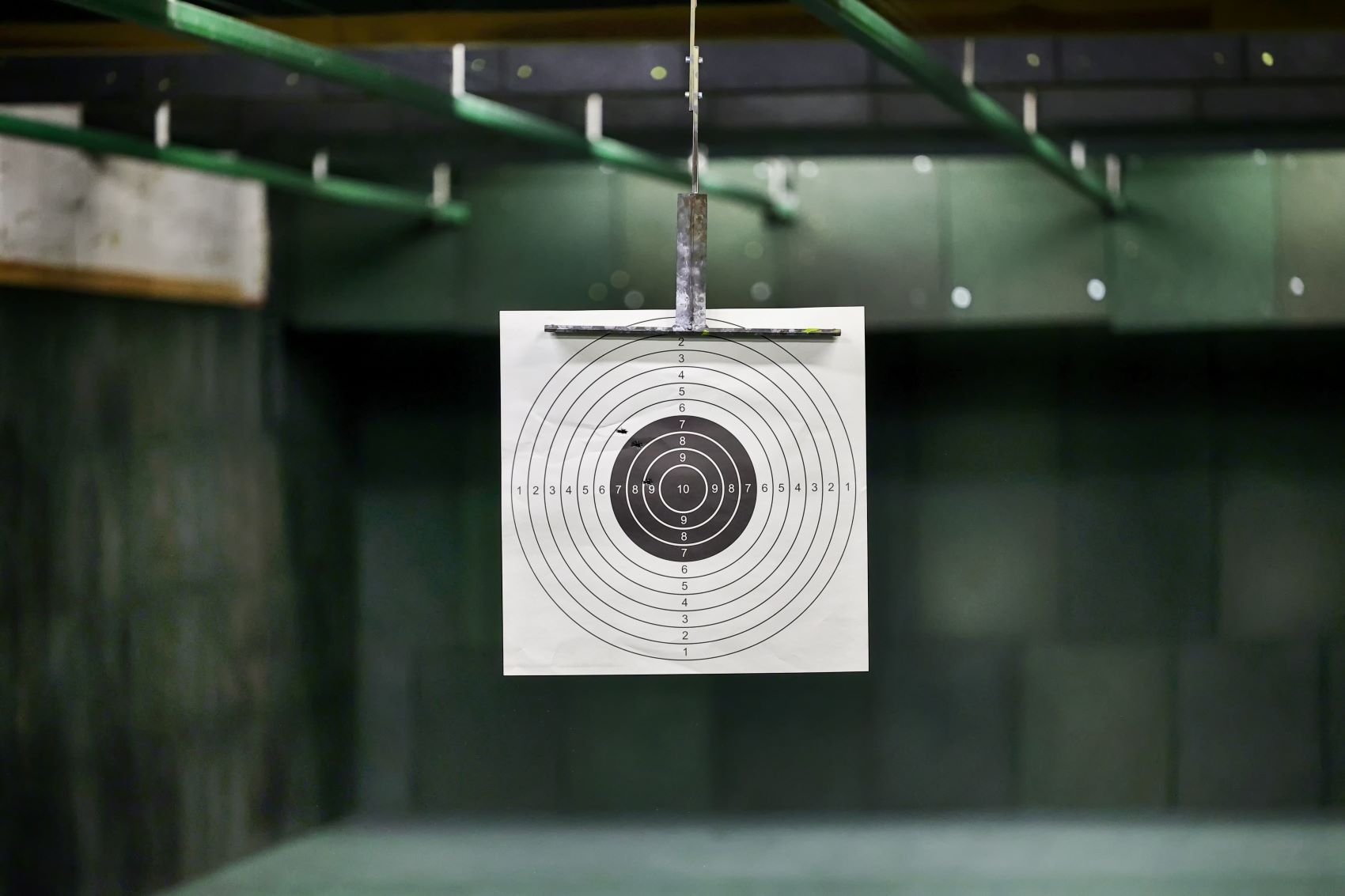 Target with concentric circles displayed in a shooting range, emphasizing accuracy for customized ammunition performance.