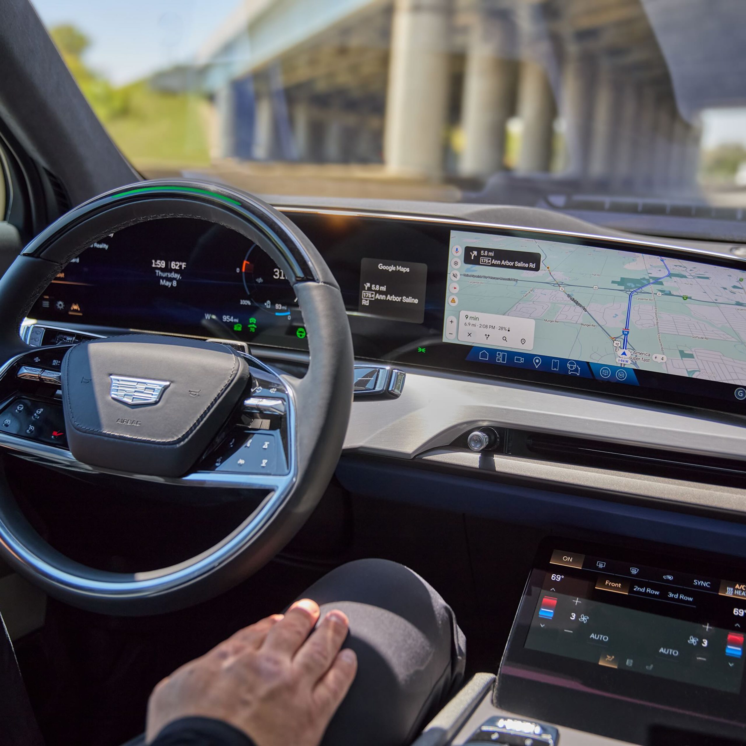 Interior view of the 2026 Cadillac VISTIQ showing the steering wheel and advanced digital dashboard controls and navigation display.