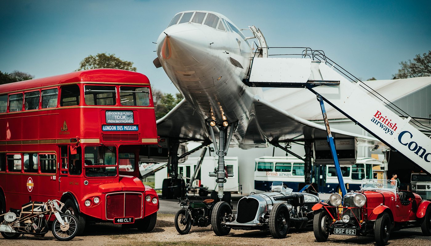 A vintage red double-decker bus, classic cars, and the Concorde aircraft at Brooklands Museum create a nostalgic transport scene.