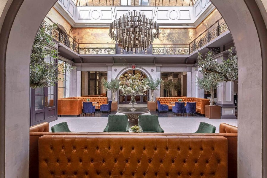 View of the elegant foyer at Oatland Park Hotel, featuring stylish seating and a grand chandelier.