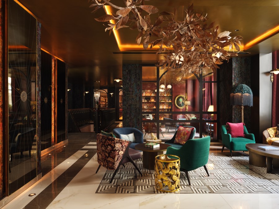 Luxurious lobby featuring vibrant seating, intricate decor, and elegant lighting, perfect for relaxation and socializing.