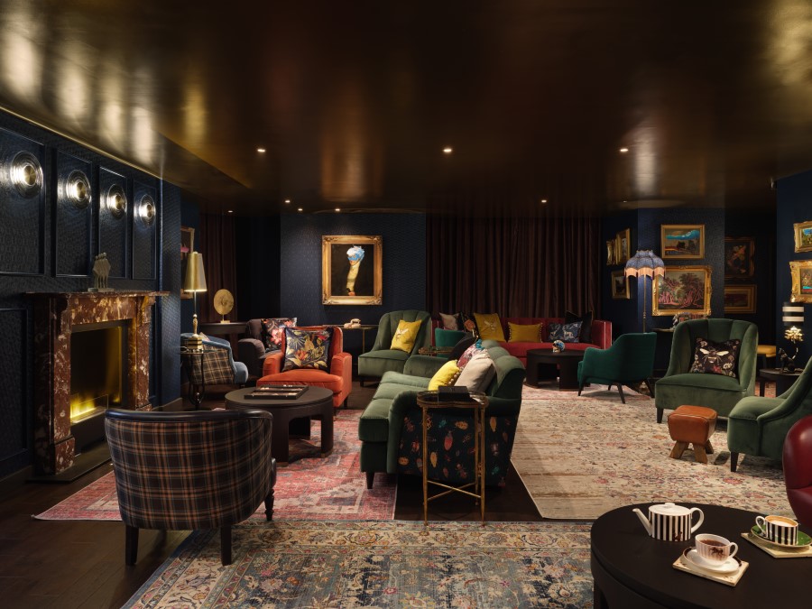 Elegant lounge with a mix of colorful seating, a warm fireplace, and stylish decor, perfect for relaxation and conversation.
