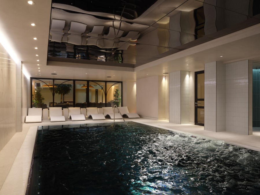 Indoor vitality pool surrounded by modern loungers, with soothing water and elegant lighting creating a serene atmosphere.
