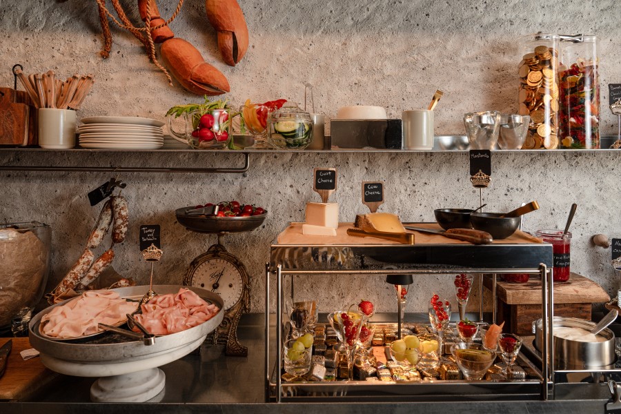A well-arranged breakfast display featuring meats, cheeses, fruits, and salads at B5 Boutique Hotel in Lugano.