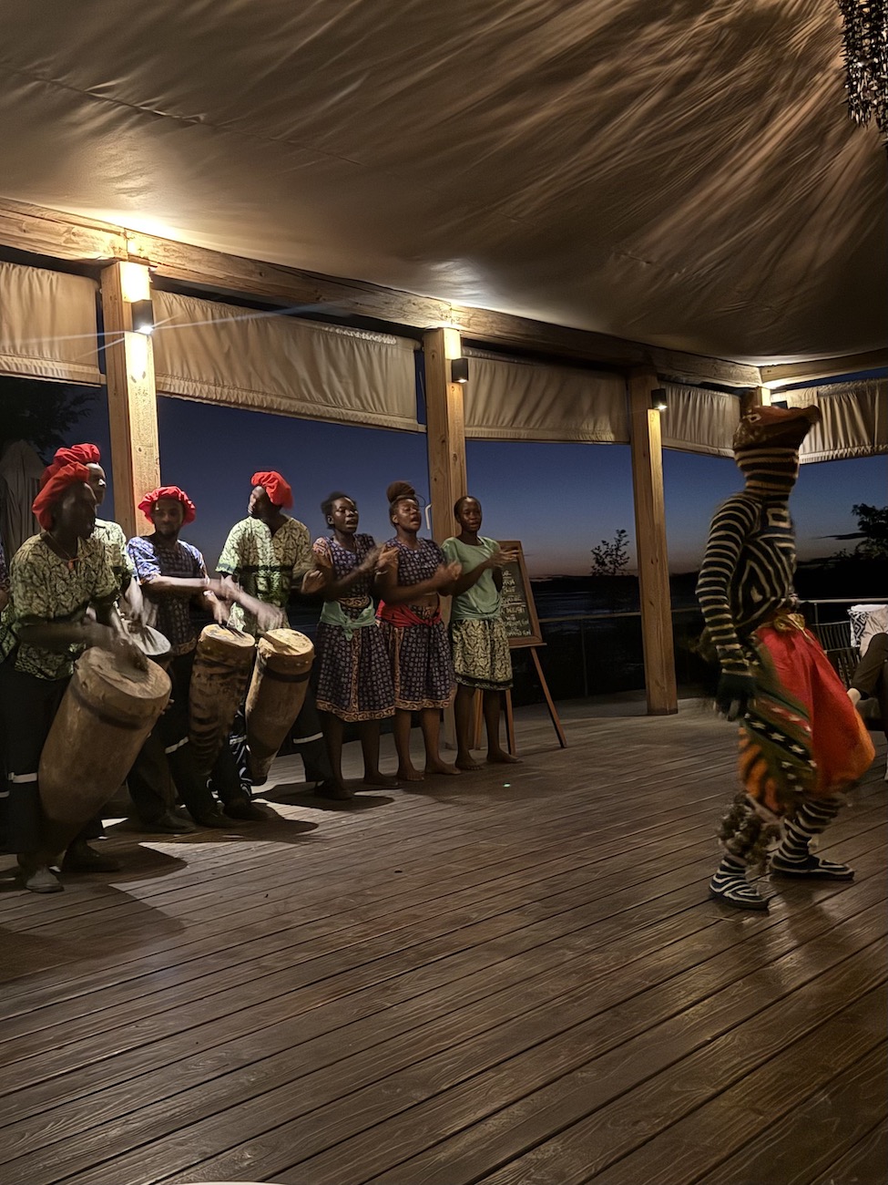 Traditional dancers perform with drums in a cultural show during the evening in Zambia.