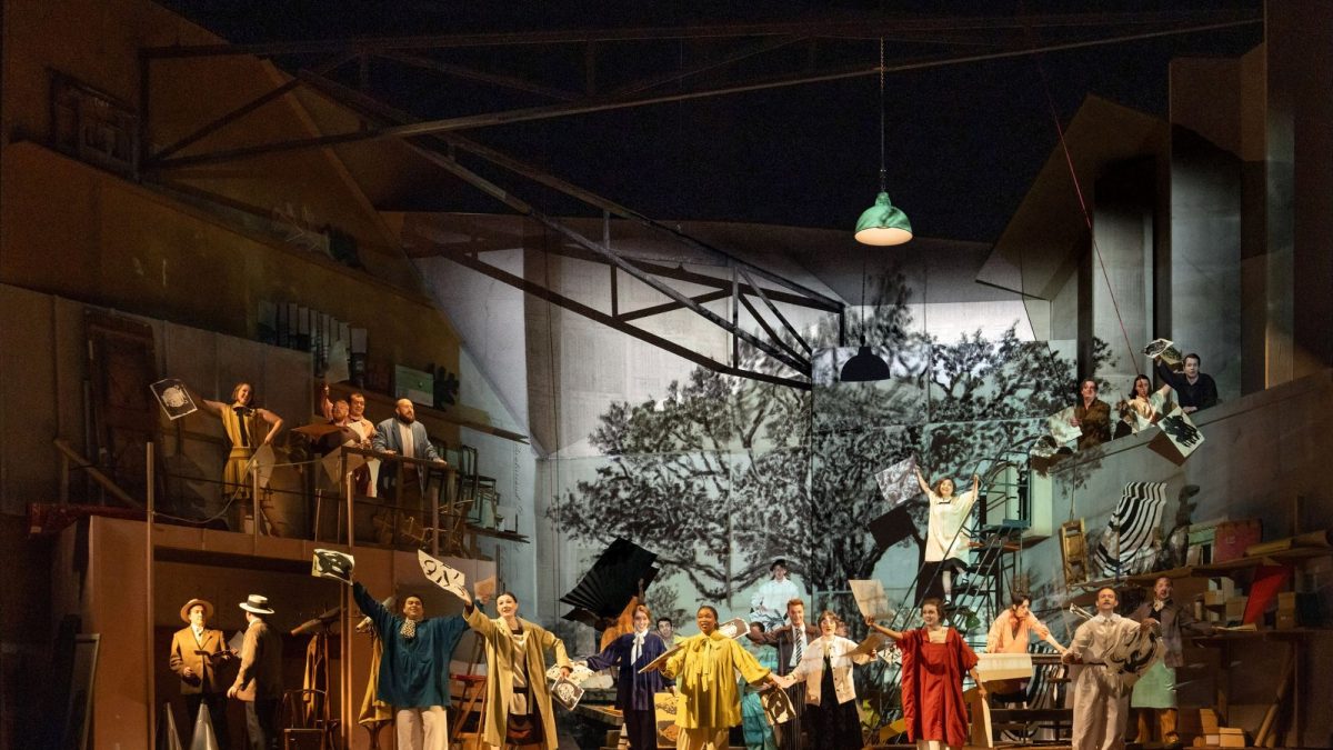 A vibrant scene from L'Orfeo at Glyndebourne, featuring performers in colorful costumes on stage with a dramatic backdrop.