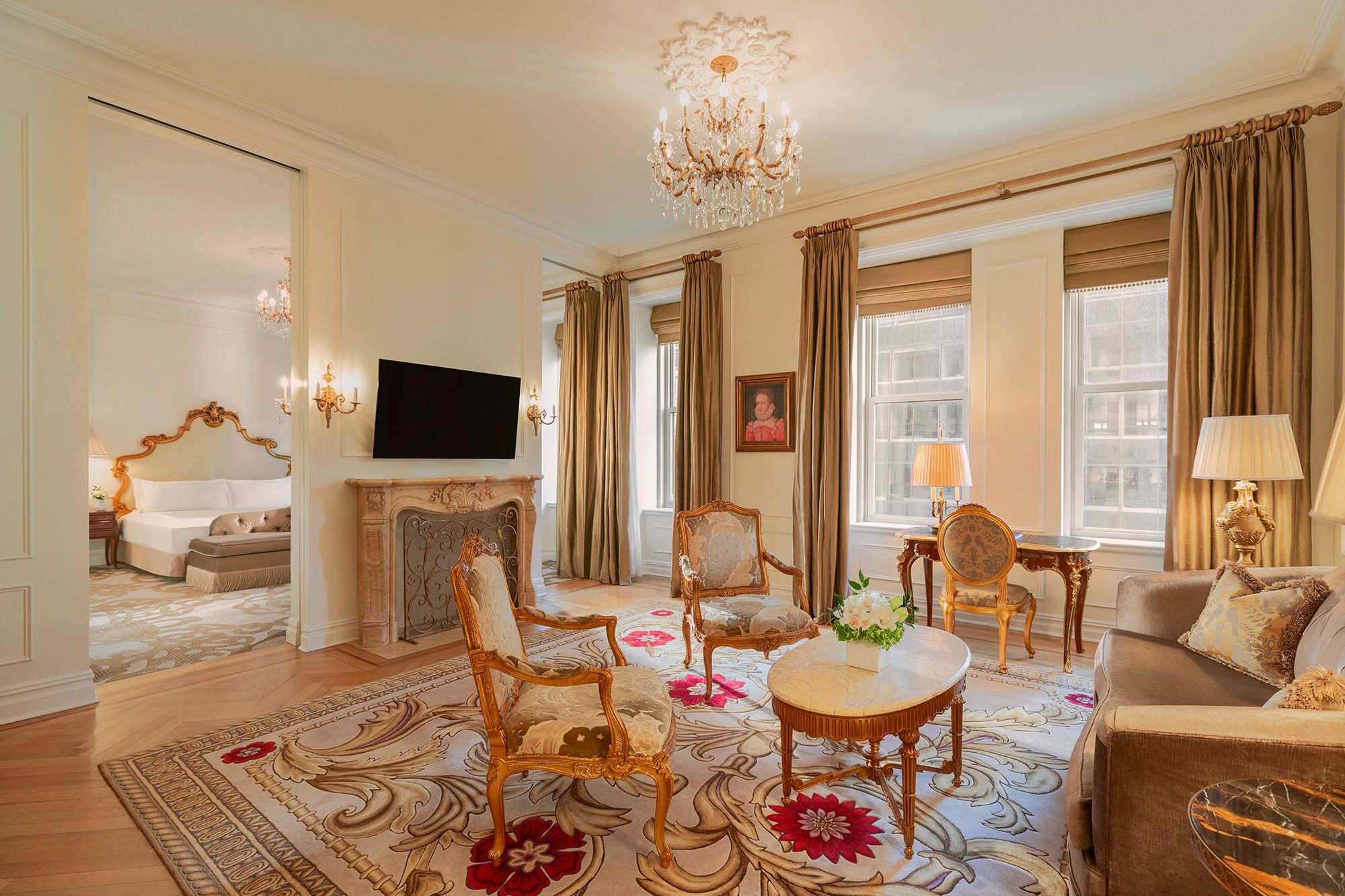 Luxurious Edwardian suite at The Plaza New York, featuring elegant furnishings, chandelier, and views of Fifth Avenue.