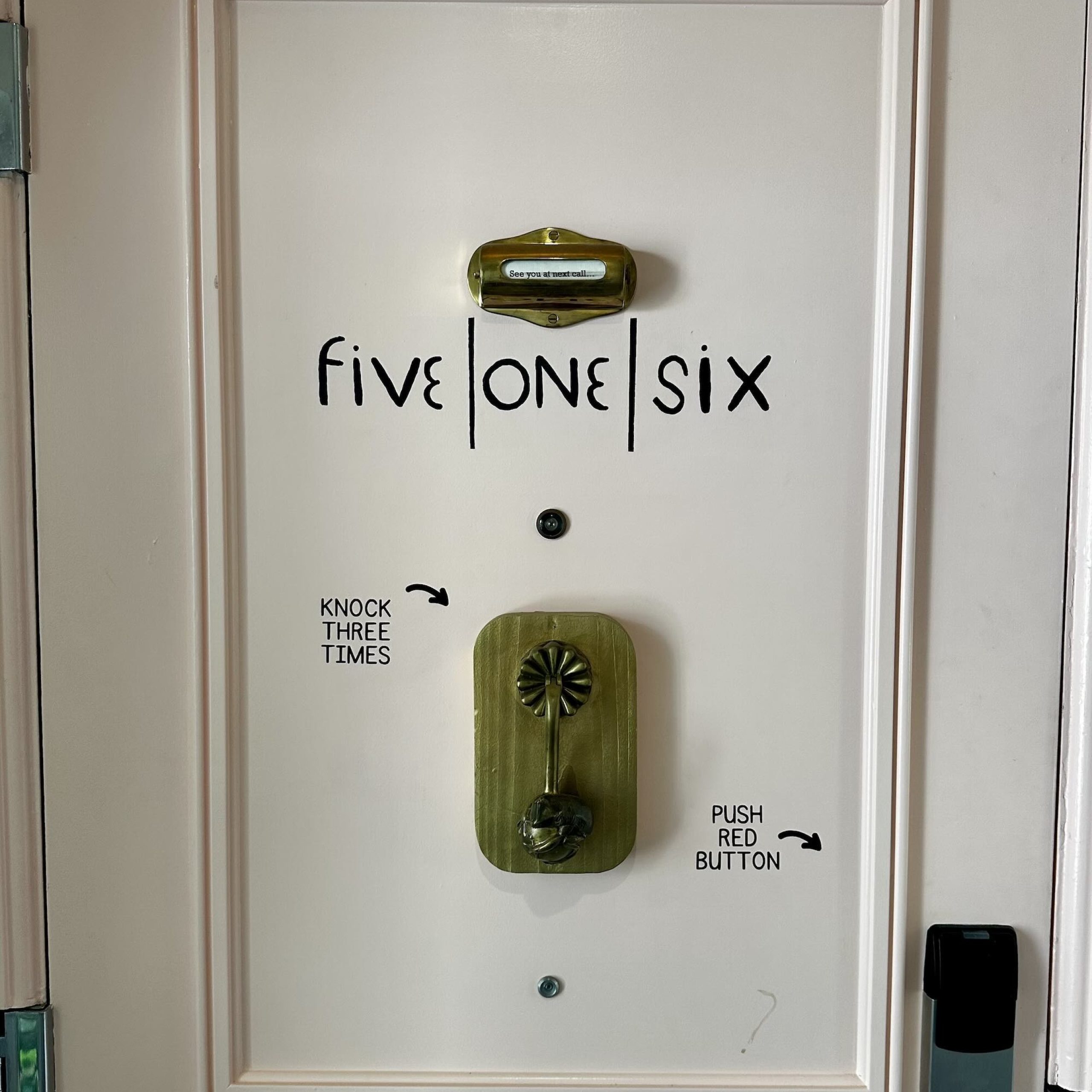 Door design at Four Seasons O'ahu featuring instructions: "Five One Six," knock three times, and push the red button.