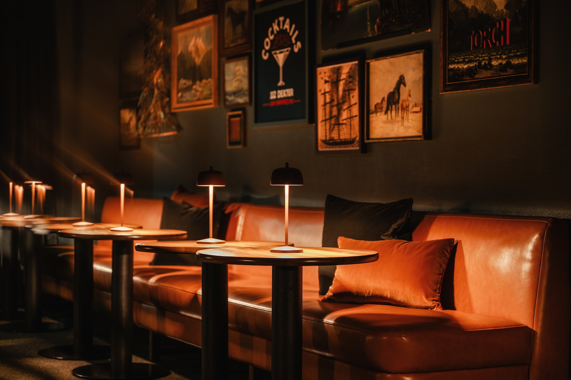 Cozy seating area with warm lighting and artwork, showcasing the ambiance of Dexter Hotel in Grand Traverse Bay.