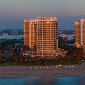 Sunrise over Amrit Ocean Resort on Singer Island, showcasing modern architecture and beachfront access.