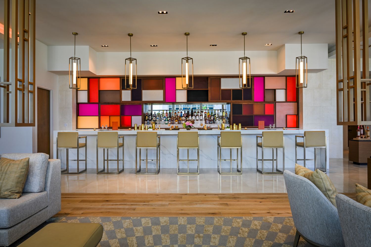 Stylish bar area with colorful backlighting and modern seating at Amrit Ocean Resort's lobby bar.