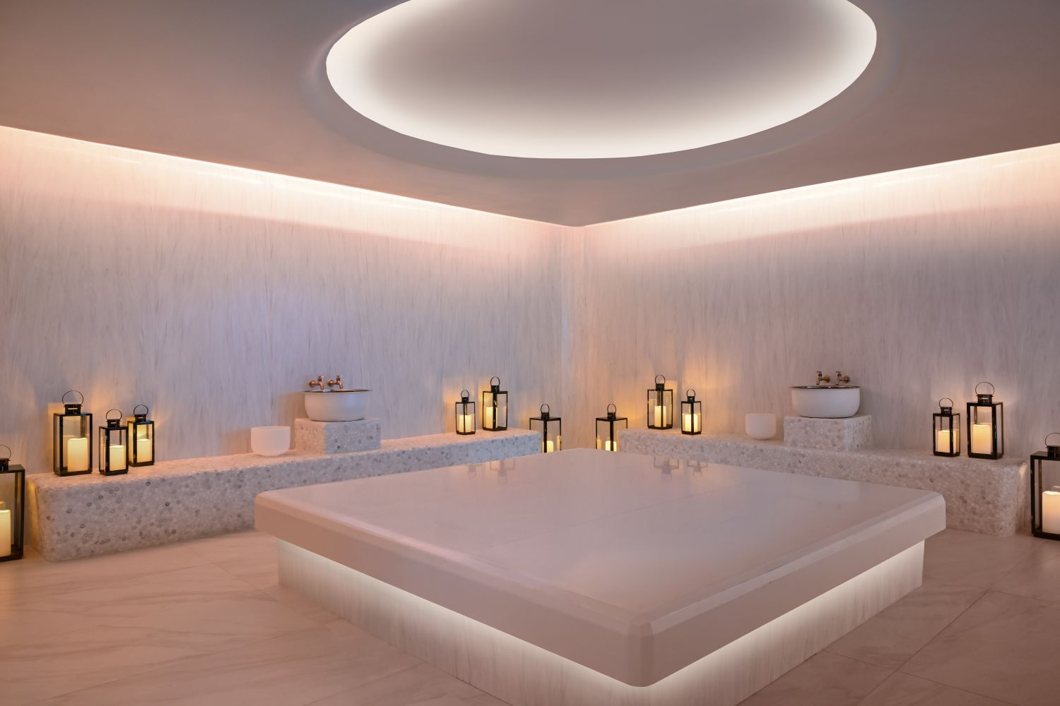 Elegant spa room featuring calming lighting, lanterns, and a serene atmosphere, perfect for relaxation and wellness.