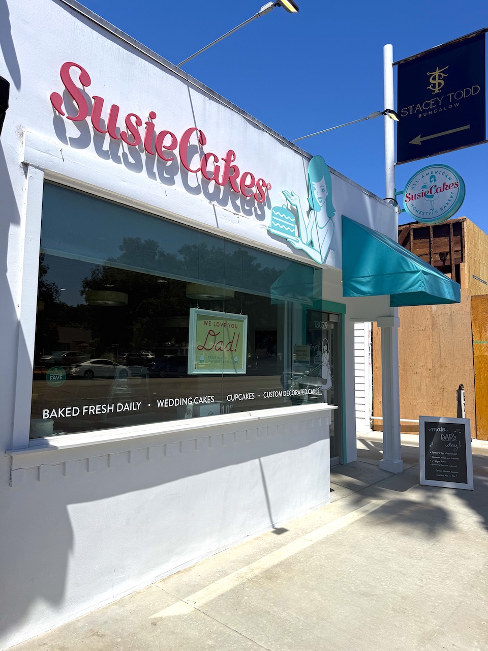SusieCakes storefront featuring a festive display for Father's Day celebrations with cakes and cupcakes.