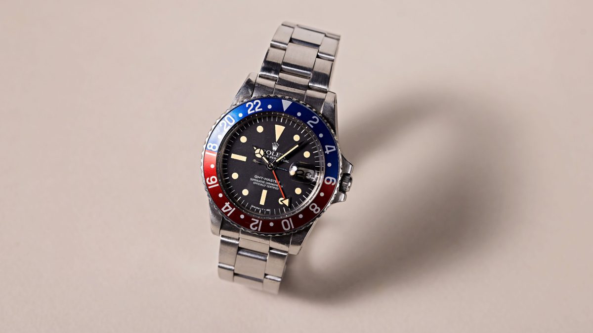 Rolex GMT-Master featuring a black dial and a blue-red bezel, symbolizing its unique heritage and connection to aviation history.