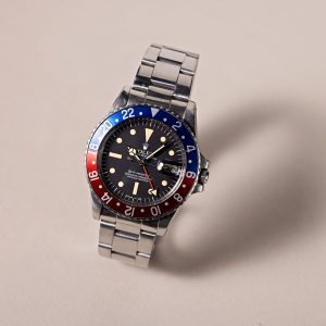 Rolex GMT-Master featuring a black dial and a blue-red bezel, symbolizing its unique heritage and connection to aviation history.