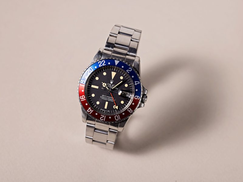 Rolex GMT-Master featuring a black dial and a blue-red bezel, symbolizing its unique heritage and connection to aviation history.