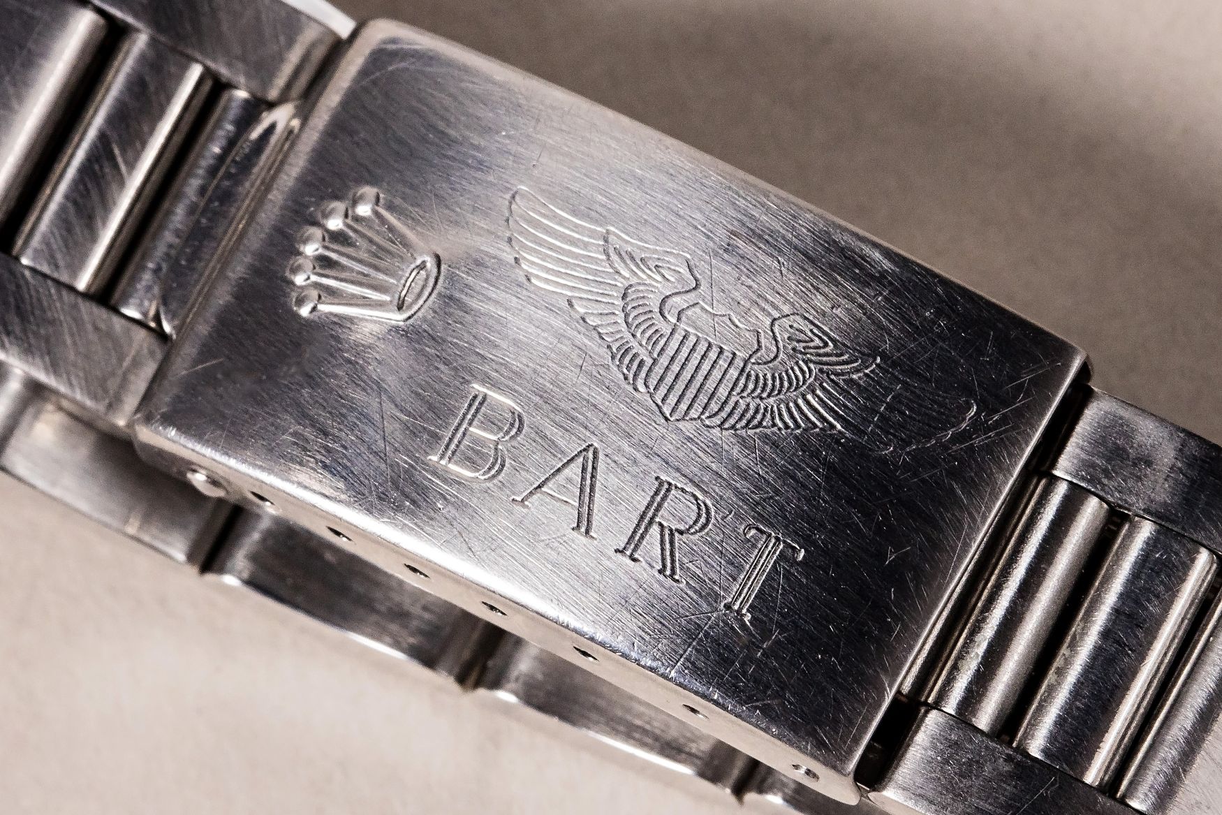 Engraved clasp of a Rolex GMT-Master, featuring a crown logo and the name "BART".