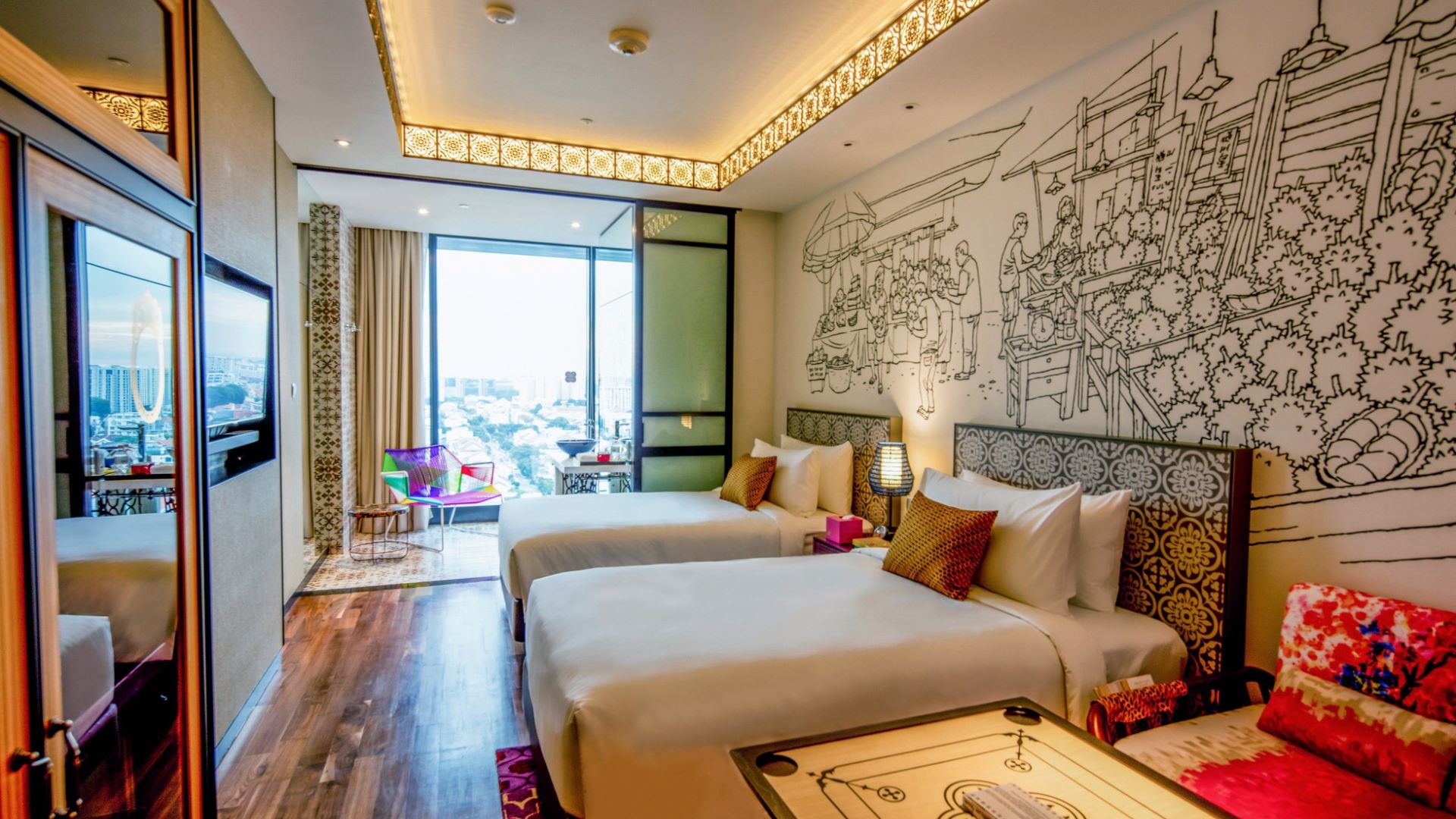 Room with two twin beds, a colorful chair, and a scenic view, featuring artistic wall designs reflecting cultural heritage.