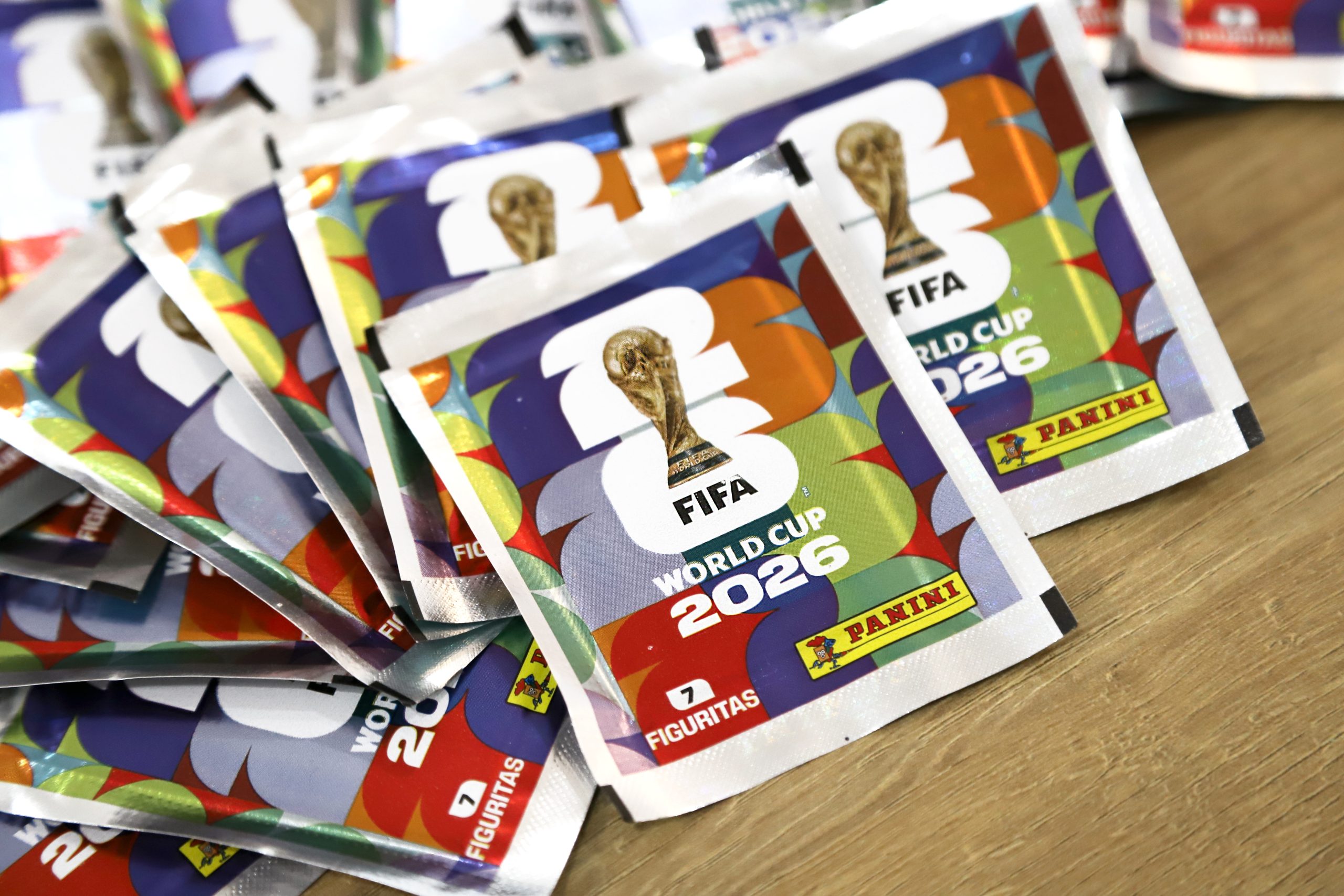 Colorful foil packets featuring FIFA World Cup 2026 branding, likely collectible stickers from Panini.